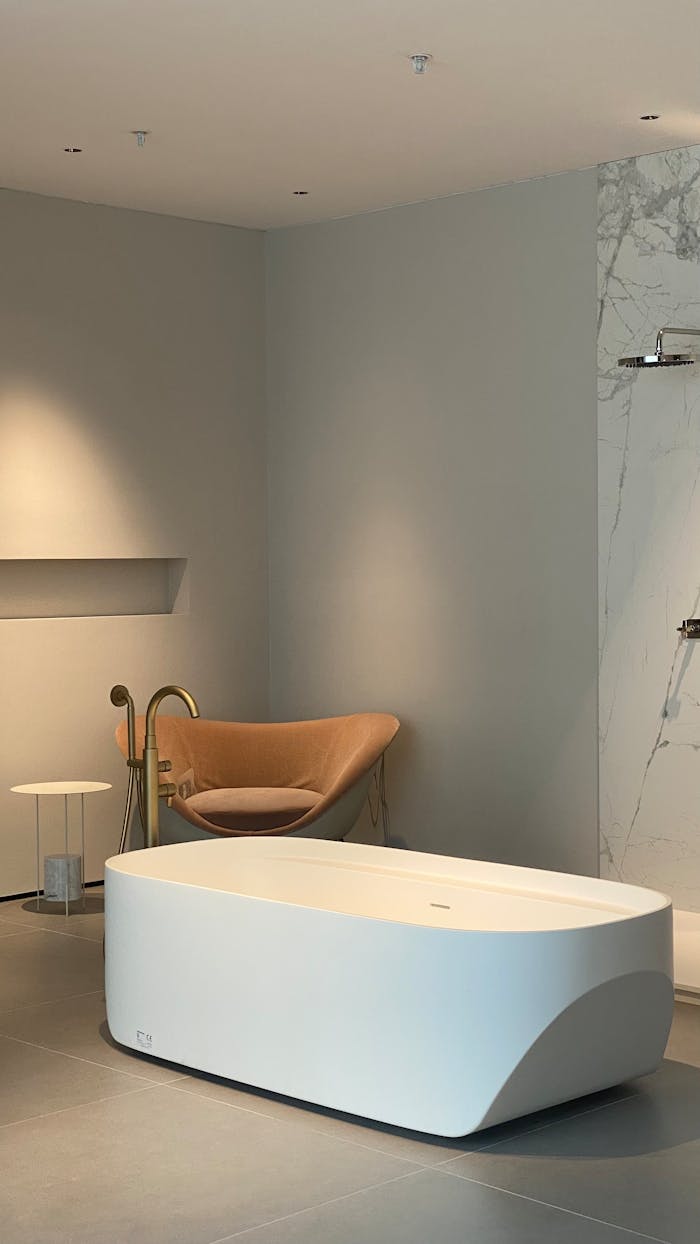 A sleek, modern bathroom featuring a freestanding tub, stylish fixtures, and minimalistic decor.